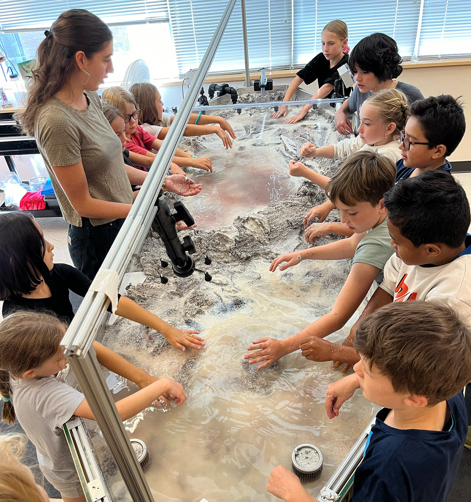 Kiri teaching 4th grades how to use the stream table.